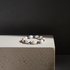 Pearl bracelet on a textured stone surface with a dark background